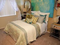Spacious bedrooms with plush, neutral carpeting and large windows. - Chardonnay Ridge Apartamentos in Modesto, California