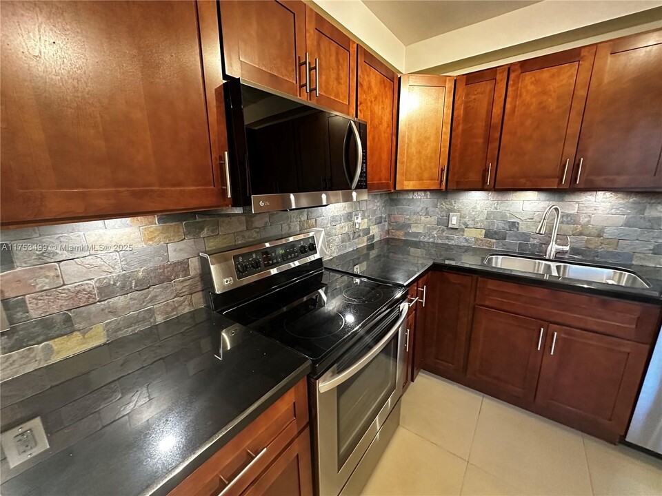 3520 Oaks Way, Unit 407 in Pompano Beach, FL - Building Photo