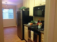 Gourmet galley style kitchens with oak cabinetry are also available. - Summerview Apartments in Modesto, California