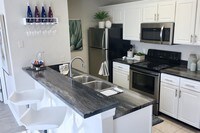 Take advantage of our premium renovation package and enjoy black fusion counter tops in your kitchen. - Domain 3201 Apartments in Tucson, Arizona