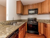 Upgraded Kitchen - Woodland Trio Apartments in Los Angeles, California