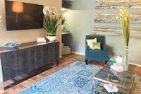 Spacious, open living rooms featuring a built-in shelving space. - Domain 3201 Apartamentos in Tucson, Arizona