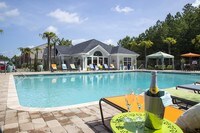 Resort-style pool featuring chase lounges and seating areas. - The Legends at Lake Murray Apartments in Columbia, South Carolina
