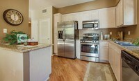 Select kitchens feature stainless steel appliances and include granite countertops - Palazzo East Apartments in Los Angeles, California