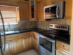 100 Village Green Cir E-Unit -101 in Palm Springs, FL - Building Photo - Building Photo