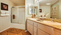 Many bathrooms feature double-sink vanities with plenty of countertop space and walk-in showers - Palazzo East Apartments in Los Angeles, California