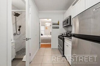 Modern 2BR/2BA in Prime Chinatown | Quick Access to Midtown & Google HQ in New York, NY - Building Photo - Building Photo