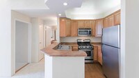 Kitchen with Stainless Steel Appliances - Academy Village Apartments in Los Angeles, California