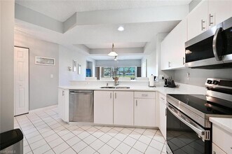 1070 Woodshire Ln-Unit -E103 in Naples, FL - Building Photo - Building Photo