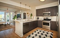 Kitchen with Stainless Steel Appliances and Hard Surface Flooring - The Hesby Apartments in Los Angeles, California