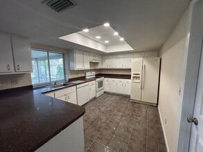 Freshly painted interior and new carpet in living room spacious home off Country Club Blvd in Cape Coral, FL - Building Photo - Building Photo