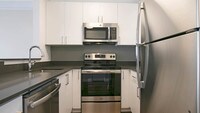 Kitchen with Stainless Steel Appliances - The Encore Apartments in Los Angeles, California