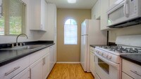 Kitchen with Dishwasher - Ridgewood Village Apartamentos in San Diego, California