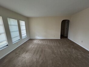 Freshly painted interior and new carpet in living room spacious home off Country Club Blvd in Cape Coral, FL - Building Photo - Building Photo