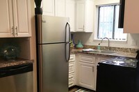 Newly updated kitchens featuring a built-in pantry are and a dishwasher. - Country Manor Apartments in Springfield, Massachusetts