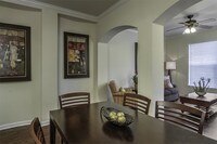 Open floor plans with arched hallway entrances and dining rooms - Reserve At Beachline Apartments in Orlando, Florida
