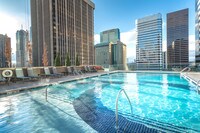Glass-sided pool and spa with skyline views - The Quincy Apartamentos in Denver, Colorado