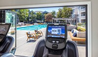 Cardio equipment with personal TV screens - Saybrook Pointe Apartment Homes in San Jose, California