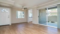 Living Room with Hard Surface Flooring and Patio - The Village at Del Mar Heights Apartments in San Diego, California