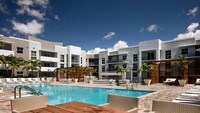 Hotel-inspired pool and sundeck with cabanas. - Modera Douglas Station Apartments in Miami, Florida