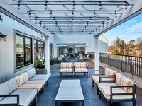 The outdoor lounge offers a glass wall to enjoy two spaces at once - Waldwick Station Apartments in Waldwick, New Jersey