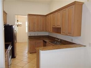 1425 Mariposa Cir-Unit -203 in Naples, FL - Building Photo - Building Photo