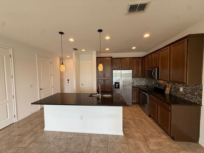 2-bedroom, 2.5-bath townhome located in Ea in Orlando, FL - Building Photo - Building Photo
