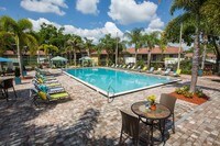 Plenty of poolside loungers for you to lay out in the Florida sunshine! - The Bentley at Maitland Apartments in Orlando, Florida