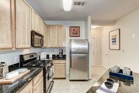 Stainless Steel Appliances And Granite Counters - Jefferson Arbors At Broadlands Apartments in Ashburn, Virginia