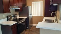 Stainless steel appliances include dishwasher, stove and refrigerator. - Bayview Apartamentos in San Diego, California